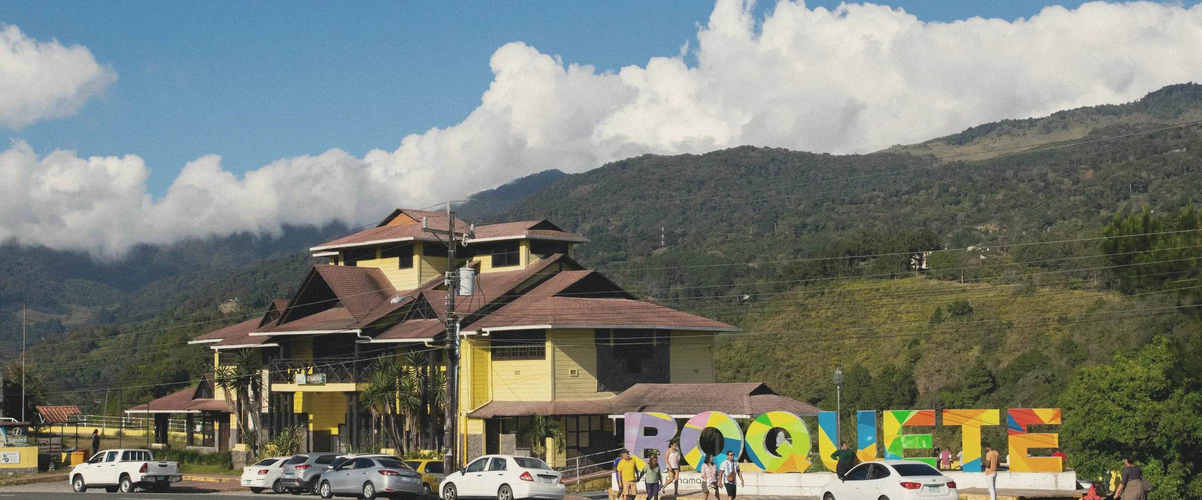 The main road into the highland town of Boquete, framed by green mountains.